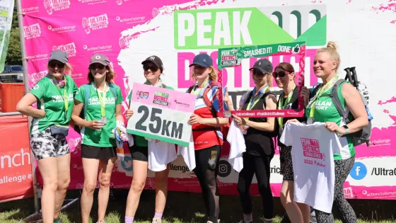 Challenge finishers posing with distance sign