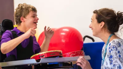 SEN teacher and pupil learning music